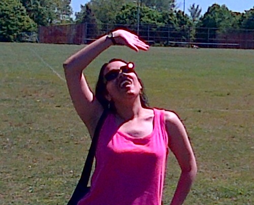 Elle performing Sun-Salutation pose in a park