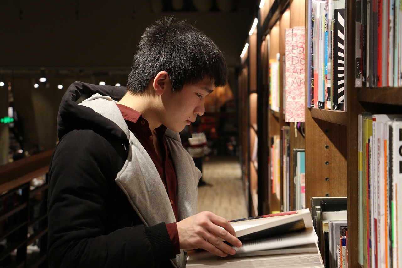 young man reading in a library
